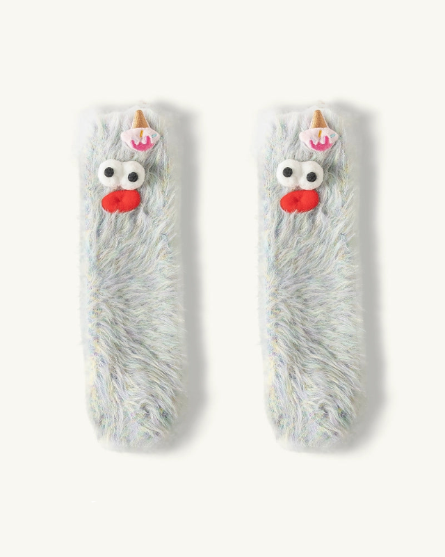 Two fluffy, cartoon-like animal toys with googly eyes and red noses on a white background.