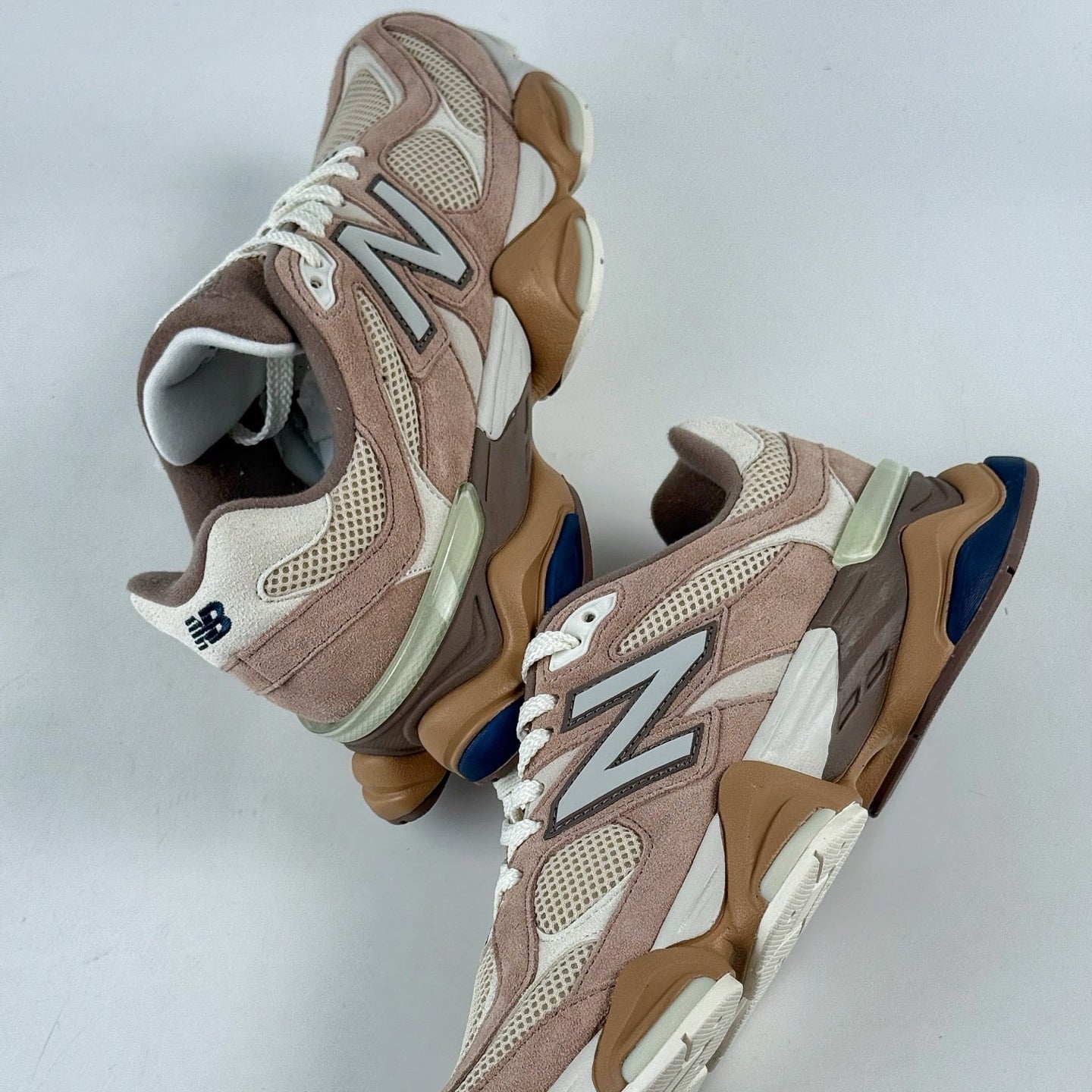 Pair of brown and beige sneakers on a light gray background