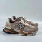 Pair of brown and beige New Balance sneakers on a white background