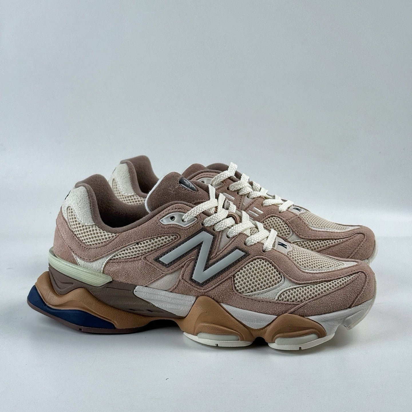 Pair of brown and beige New Balance sneakers on a white background